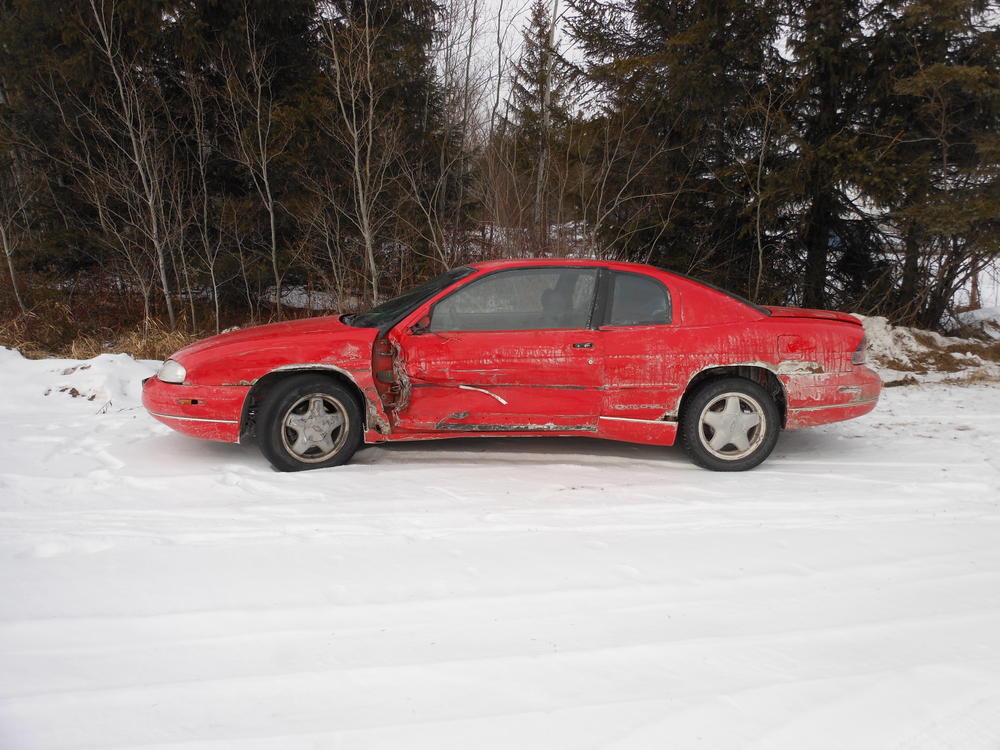 red vehicle with minor damage on left side