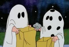 Two ghosts hold trick-or-treat bags