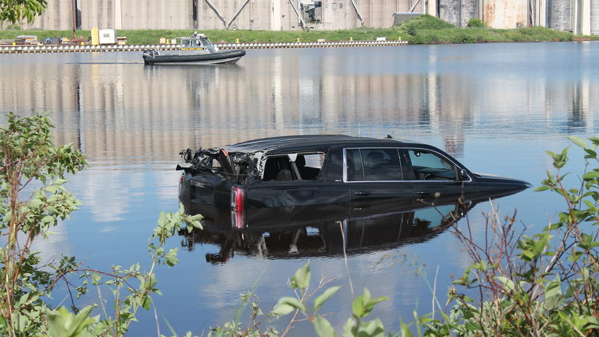 SUV submerged halfway in the water